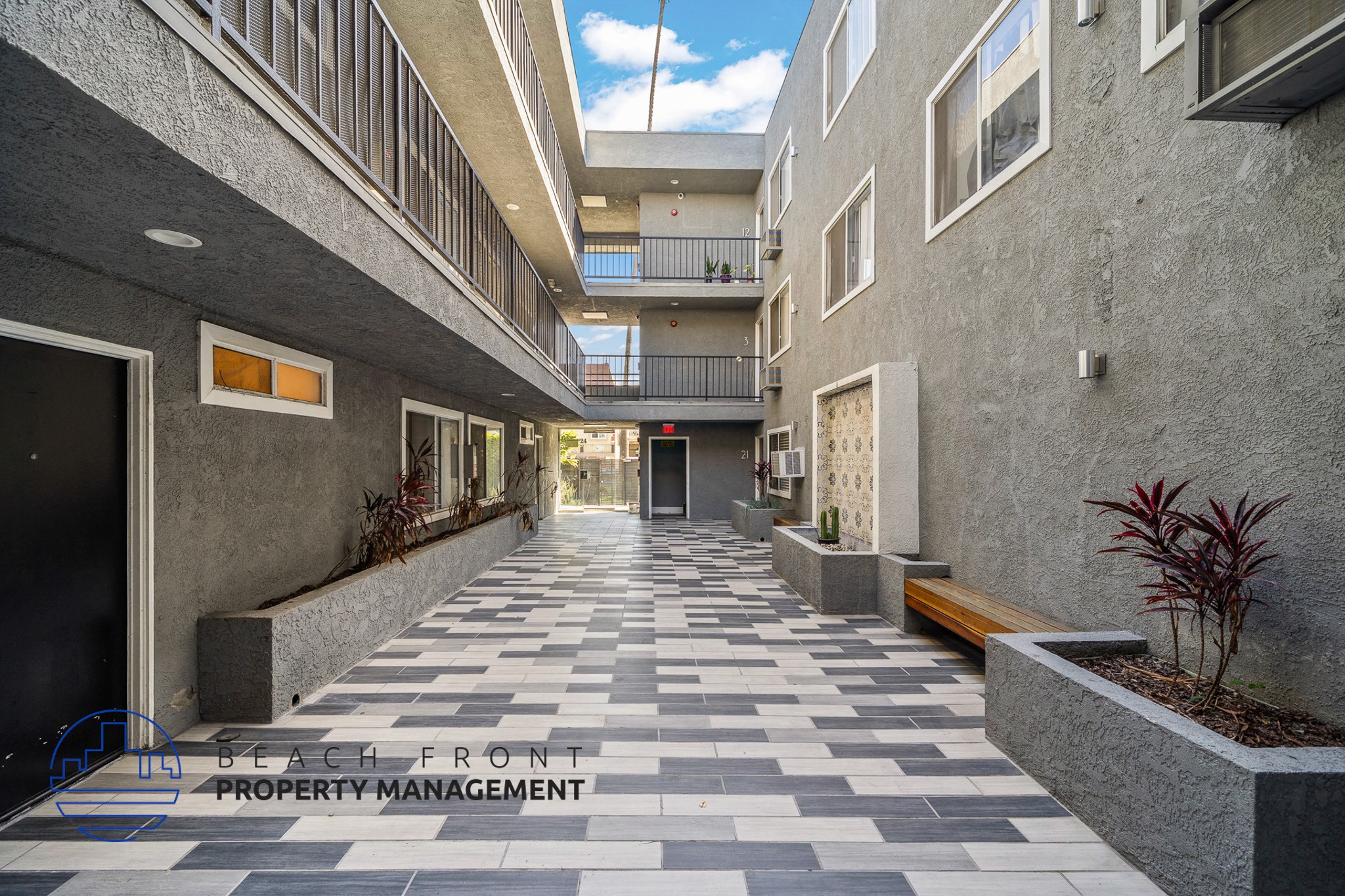 A long hallway with a tiled floor and concrete walls.